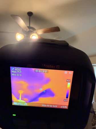 IICRC certified technician using professional thermal imaging camera to detect hidden moisture inside walls during water damage inspection in DFW TX